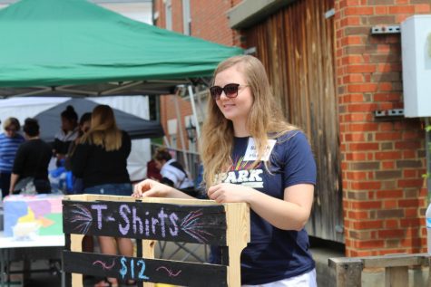 Community Actvism member selling t-shirts 