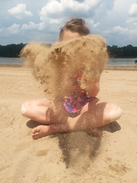 This photo was taken and captioned by Eliza Bradshaw (12), Playing with Sand. 
