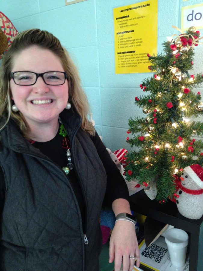 Mrs. Crager is ready for christmas as she poses next to her Christmas tree and her festive snowmen. 