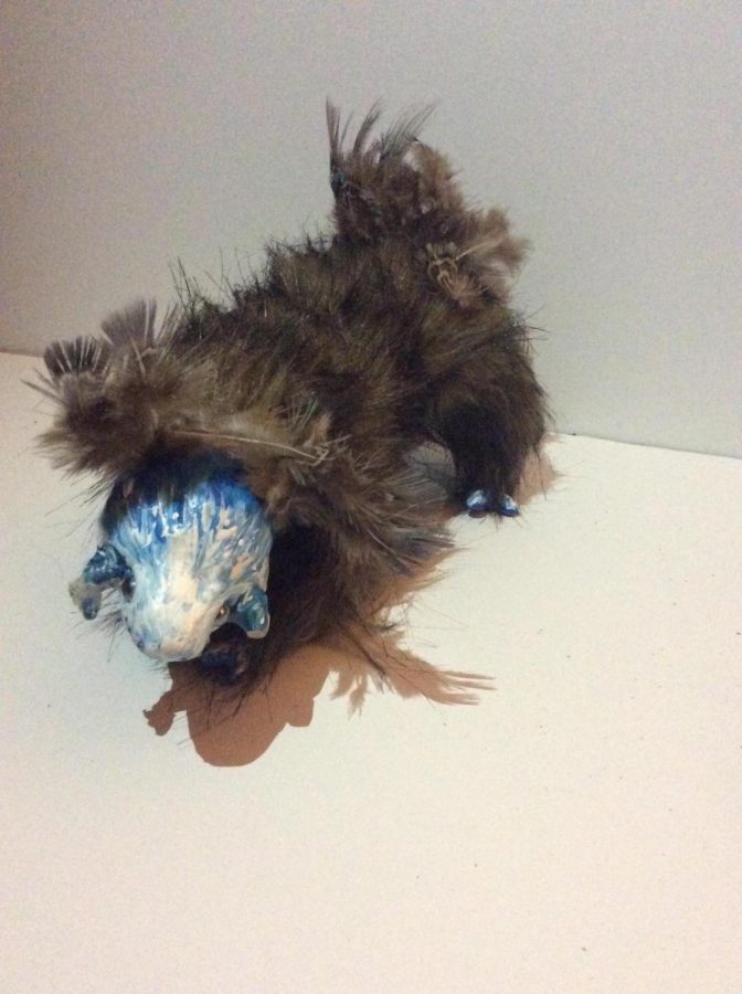 Horned Blue Creature Clay, fake fur, feathers, paint, wire, aluminum foil, and cotton batting. 