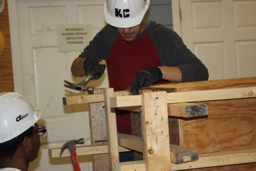 Parker Young (11) and Mark AlAamery (11)  collaborate on a project in Carpentry. 