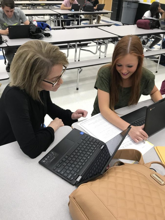 Mrs. Walters-Parker works with a student during class