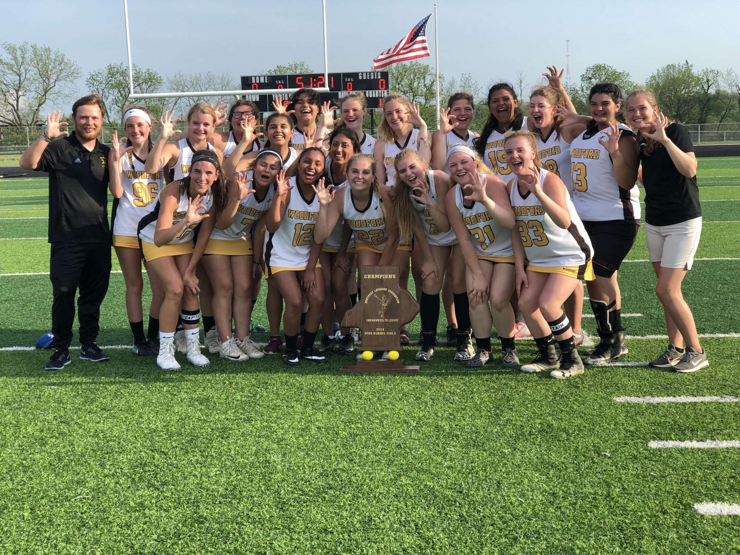 The girls of Woodford County Lacrosse with their coaches Jeff Faulkner (left) and Haven Buckner (right) on the day they won state championship