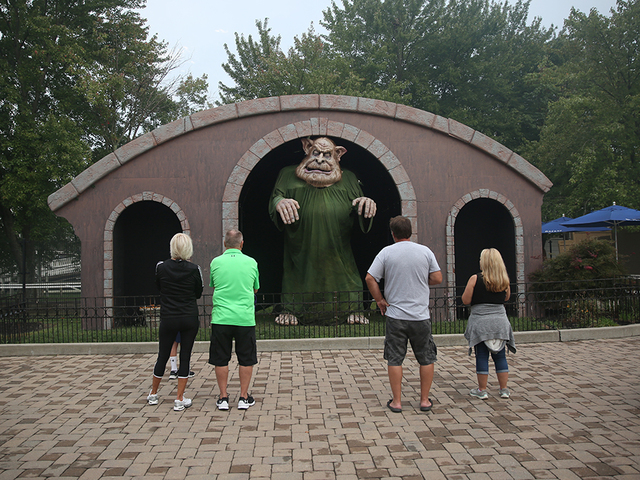 People check out a giant troll at Halloween Haunt at Kings Island transforms Kings Island into a nightmare landscape. Halloween activities include haunted mazes, outdoor scare zones, live shows and evil creatures roaming the park.