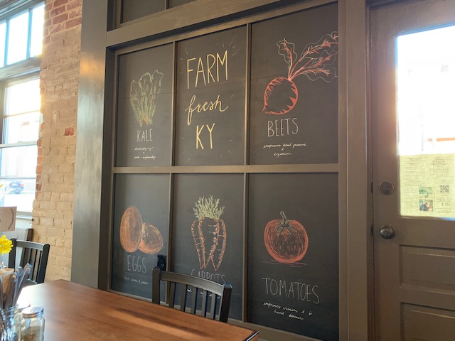 The hand-drawn sign on the chalkboard wall features a few of the farm fresh foods used in dishes made at Spark.