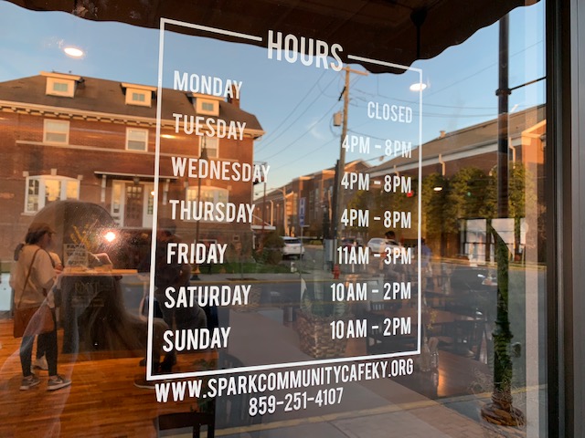 The hours for the cafe are posted on the outer glass door.