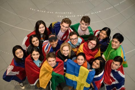International students hold the flag of the country they study in.