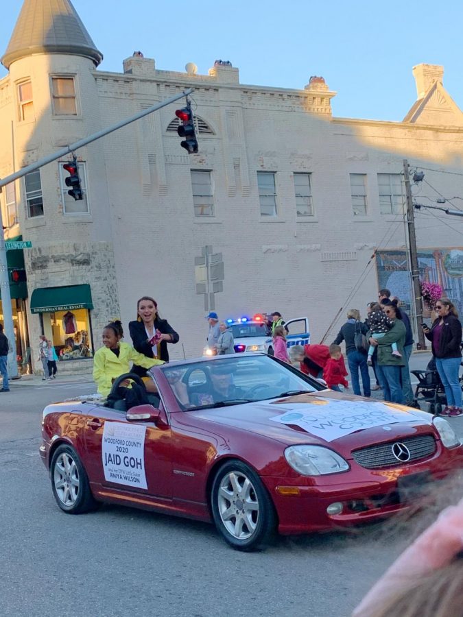Jaid Goh rides in the red convertible joined by Aniya Wilson.