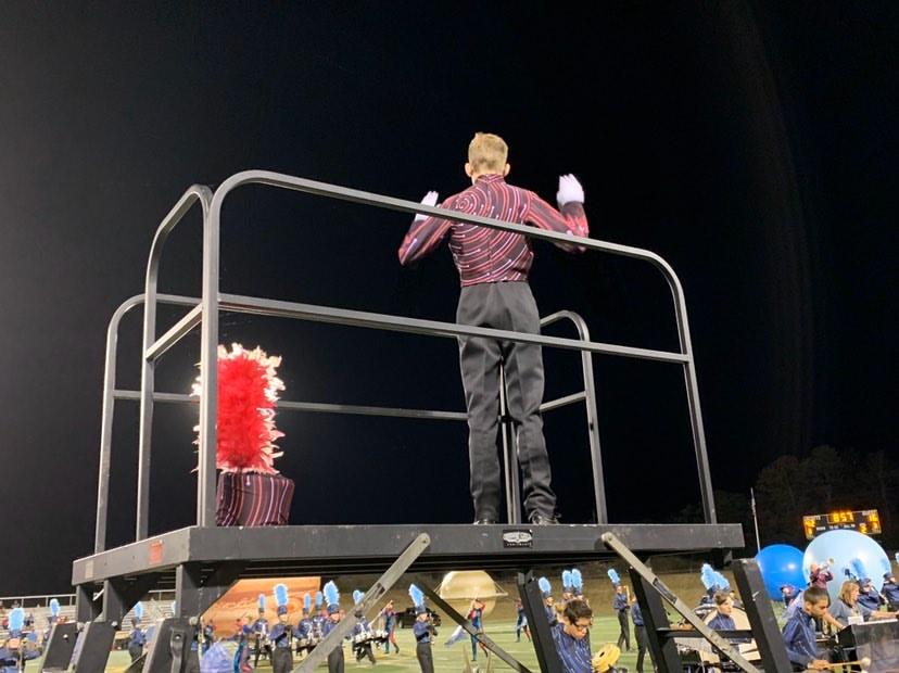 Ben Humphries (12) directing the marching band as one of the drum majors for the marching band this year.