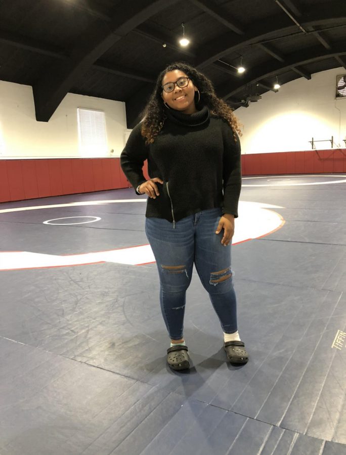 Senior (12) MaQuoia Bernabe posing in the wrestling room of the Lady Mat Patriots. 