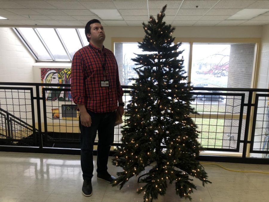 Mr.+Wilkins+stands+by+the+schools+Christmas+tree+ready+for+a+break.+Photo+by+Jamie+Hobbs.