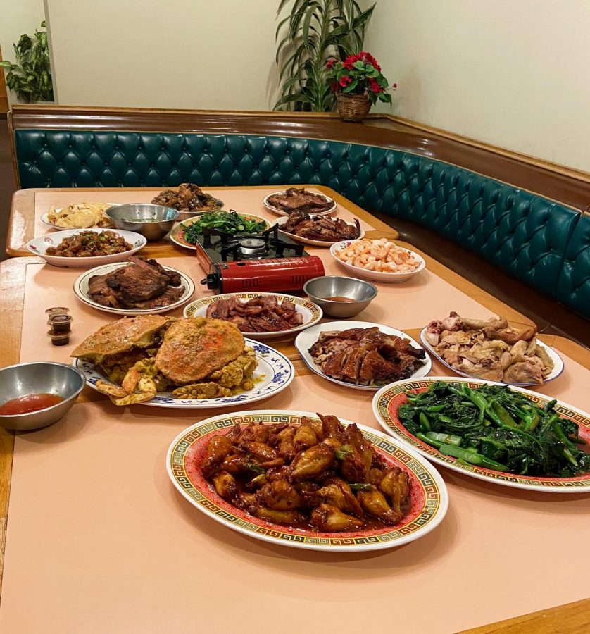 Families gather together to eat dinner and unite. Dishes are spread around the table for everyone to grab. 