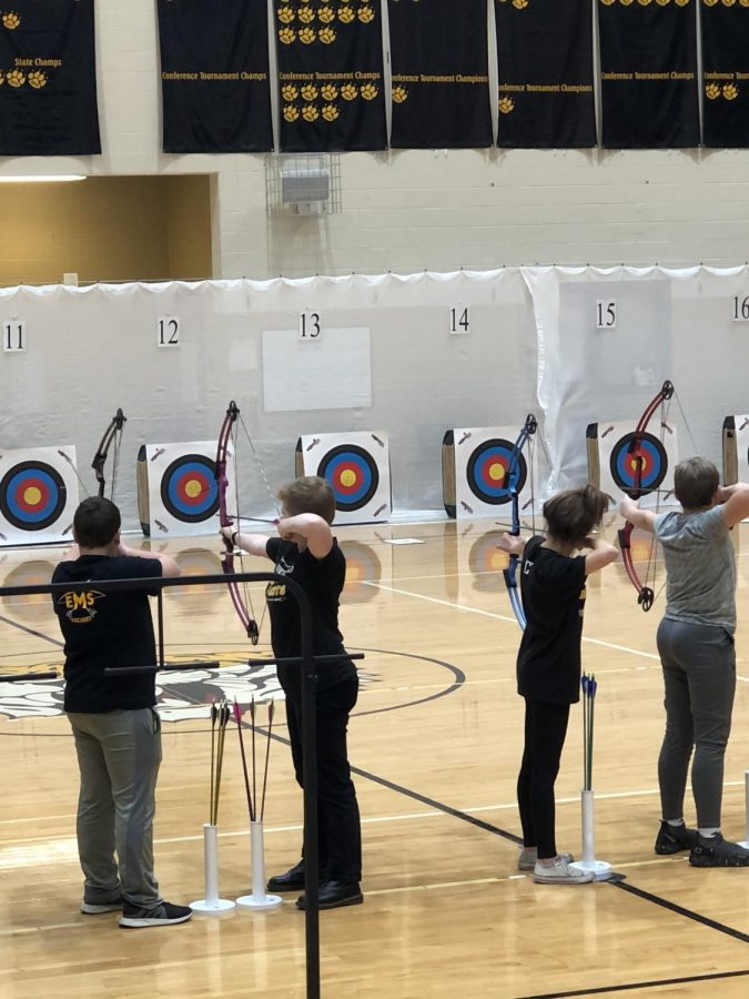 Archers line up at the 15-meter line to release their first practice shot.