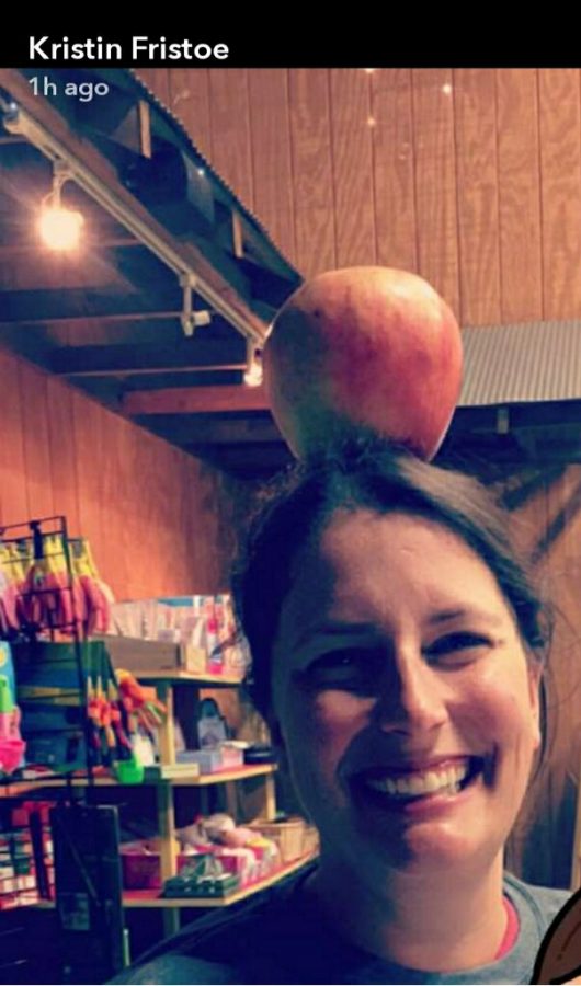 Megan Fields, the manager of Woodfords very own Eckerts Orchard out on Pinckard Pike, enjoying time in the orchard store with an apple on top of her head. 
