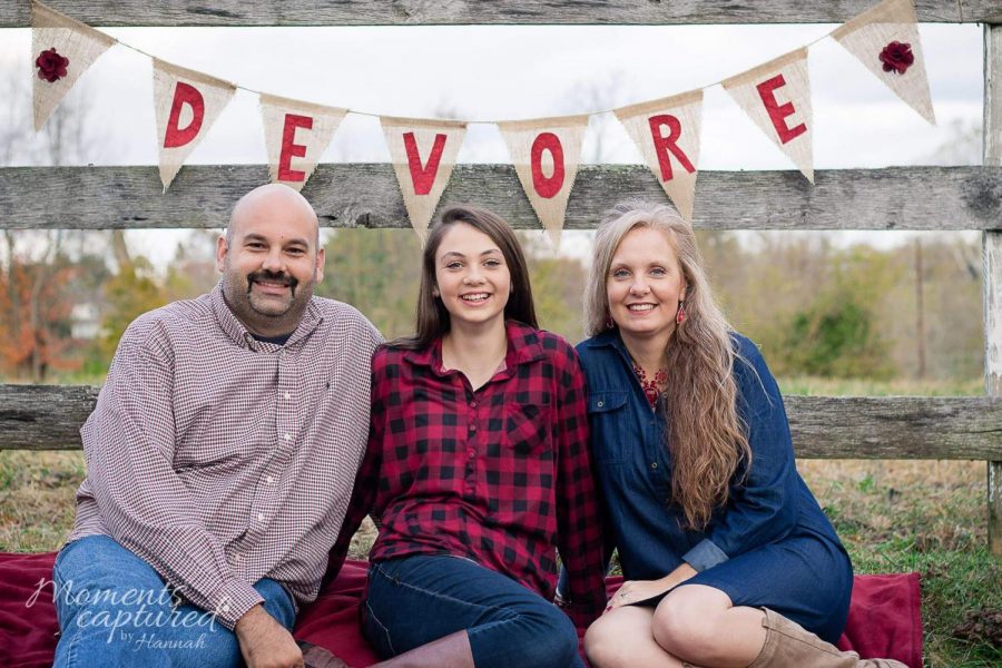 The DeVore family posies in front of their DeVore banner! 