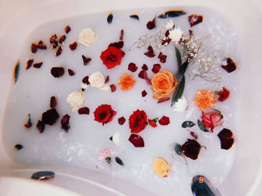 A relaxing bath with different flowers and petals