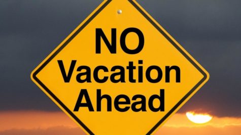 A yellow and black no vacation sign.