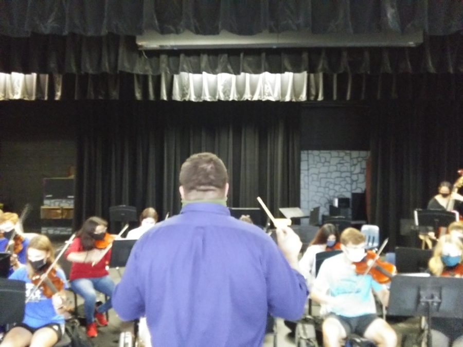 Mr. Marsee conducts the orchestra.