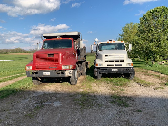 Trucks wait to be used for work on the farm.