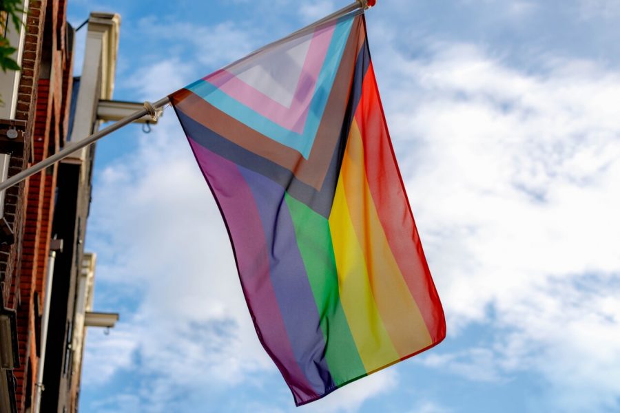 An all-inclusive pride flag waves in the wind.