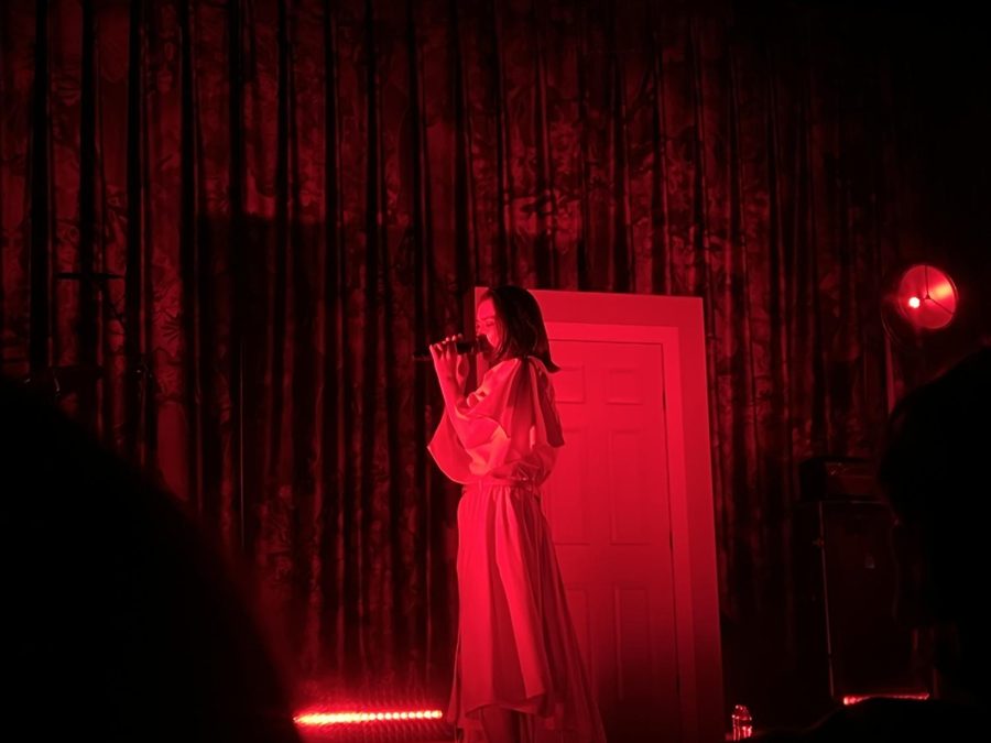 Mitski performs her single "Heat Lightning" under red lighting.