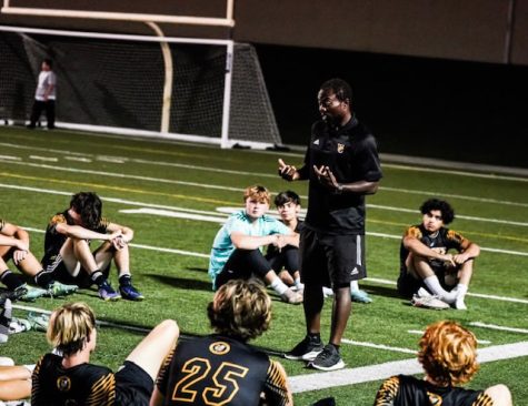 Coach Fonyam talks with the team at half (Photo by Bill Caine)
