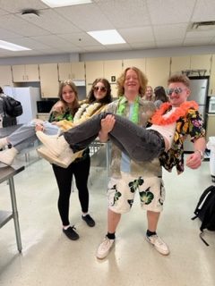 Everyday is a vacation with this crew. Students smile in their vacation outfits for spirit week. 