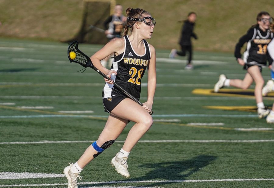 Tess Thompson (10) makes her way down the field during a lacrosse game. 