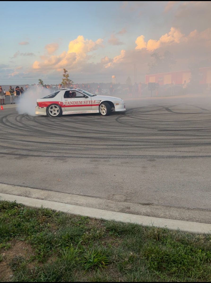 Professional tandem drift car caught in action mid drift.