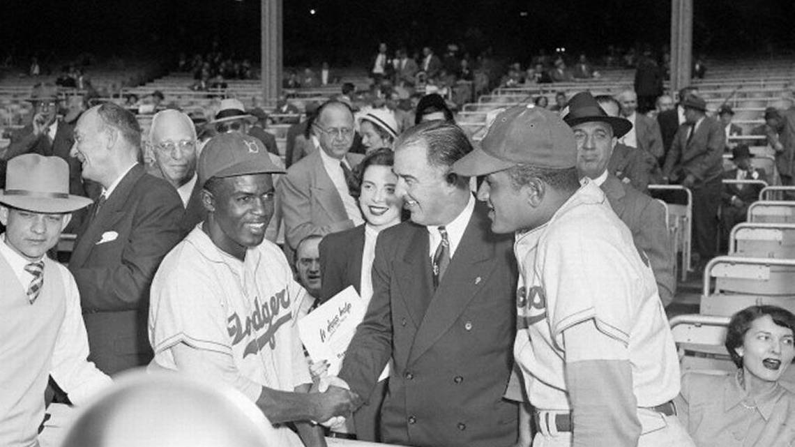 Happy Chandler shaking hands with Jackie Robinson