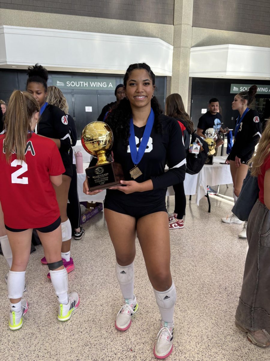 Kamya Mahorn holding the 17 U Open Gold Bracket Trophy at the Bluegrasss Louville Tournement. 