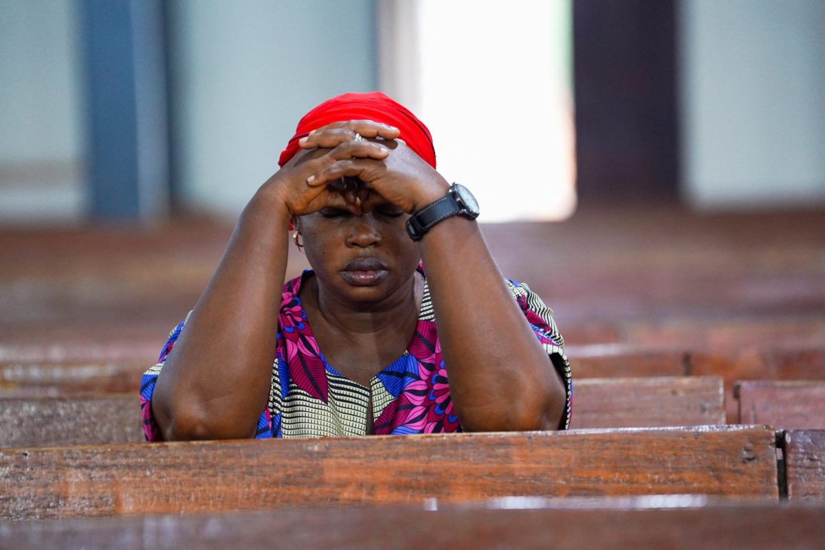 A woman prays during an evening mass at St. Michael Cathedral on Bosso Road in Minna, Niger State, Nigeria, December 4, 2025. REUTERS/Marvellous Durowaiye