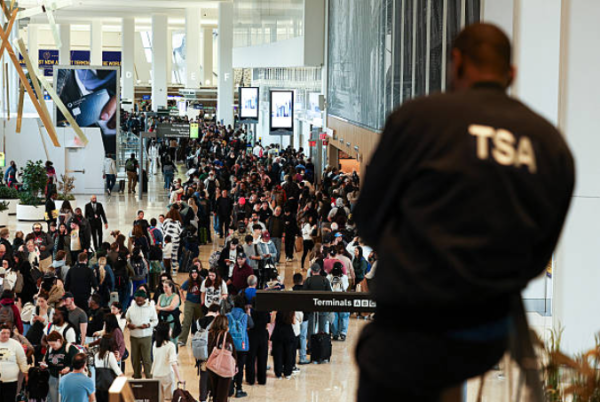 TSA agent overlooking large crowds