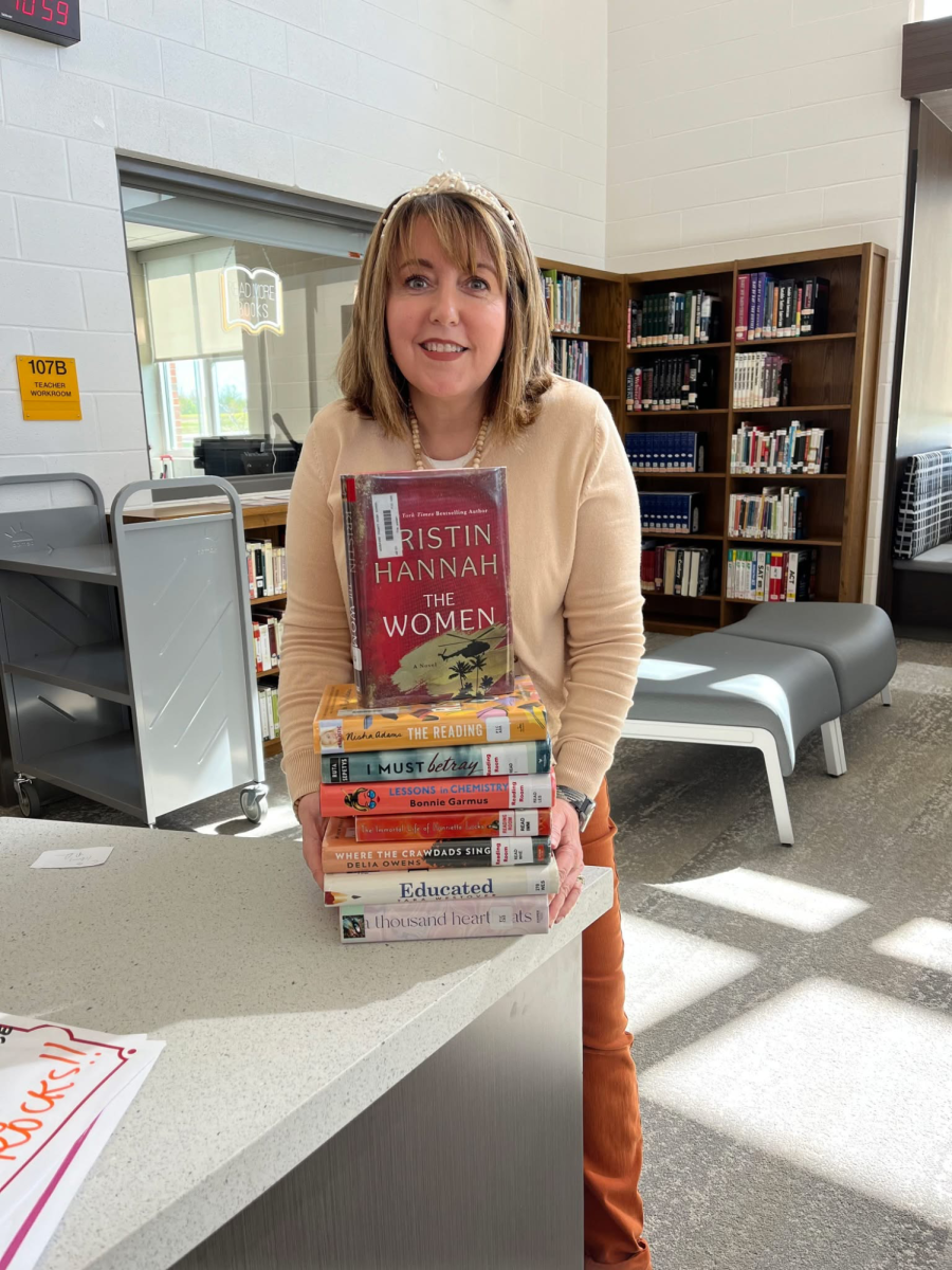 Mrs. Romine with a stack of books and quoting Mark Twain
"The man who does not read has no advantage over the man who cannot read."  