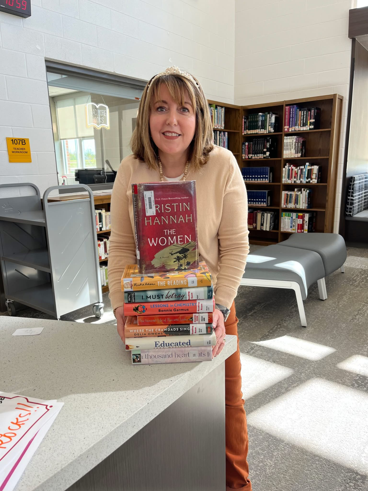 Mrs. Romine with a stack of books and quoting Mark Twain
"The man who does not read has no advantage over the man who cannot read."  